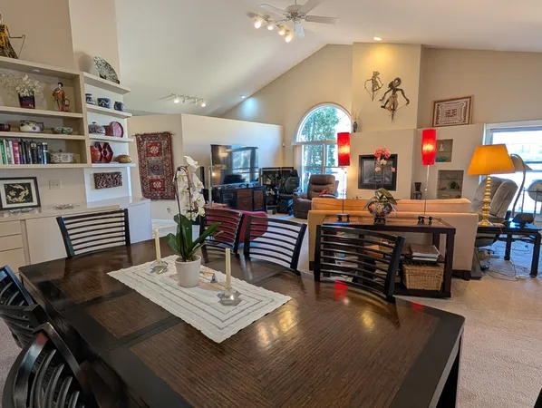 a living room with furniture and a dining table