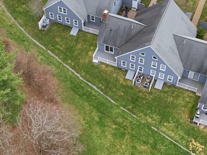 an aerial view of a house with garden space and lake view