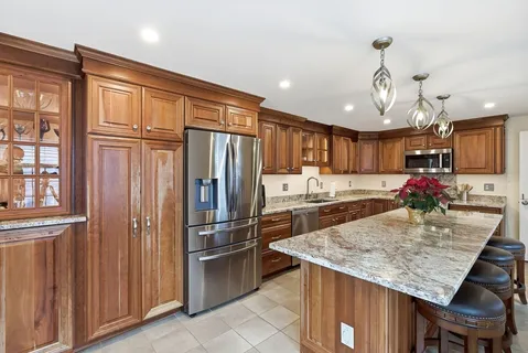 a dining room with granite countertop furniture and a chandelier