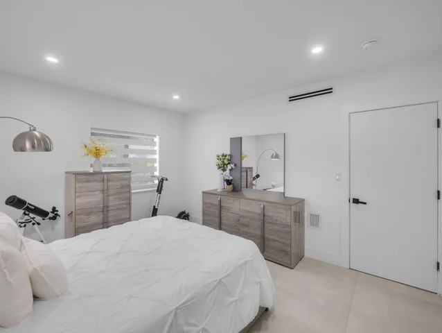 a bedroom with a bed and a dresser