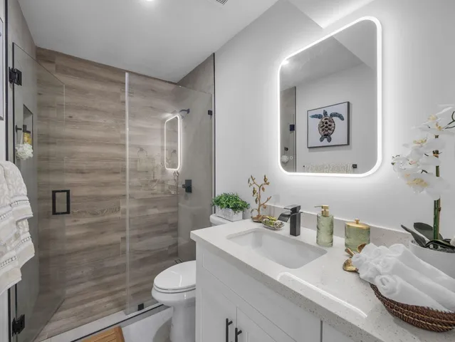 a bathroom with a sink toilet and shower