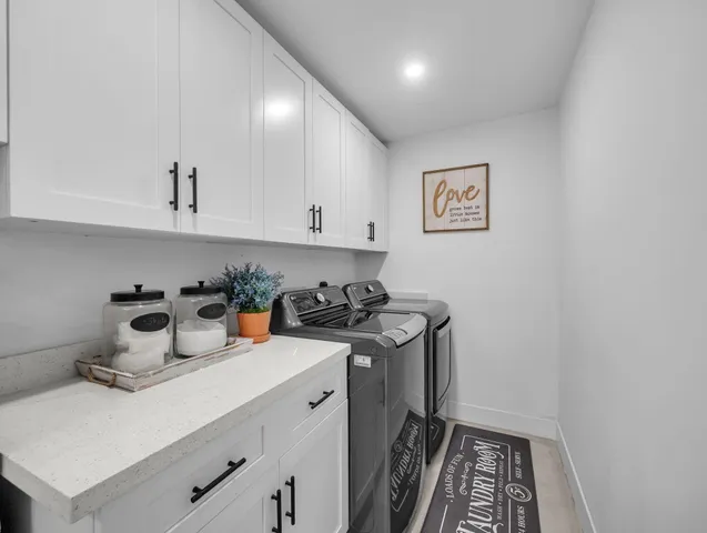 a view of a kitchen with sink and cabinets