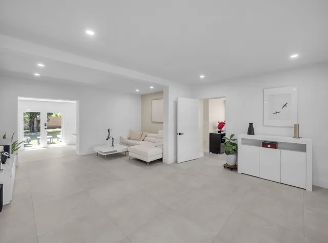 a living room with furniture and flowers