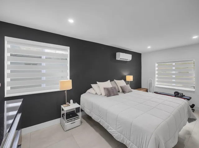 a bedroom with a bed and window