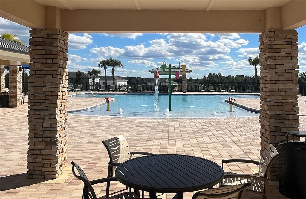 6863 Spanish Imperial Street Howey-in-the-Hills, FL 34737 - Photo 7 of 10 a view of swimming pool with outdoor seating and yard