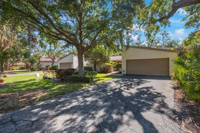 a view of a house with a yard and tree s