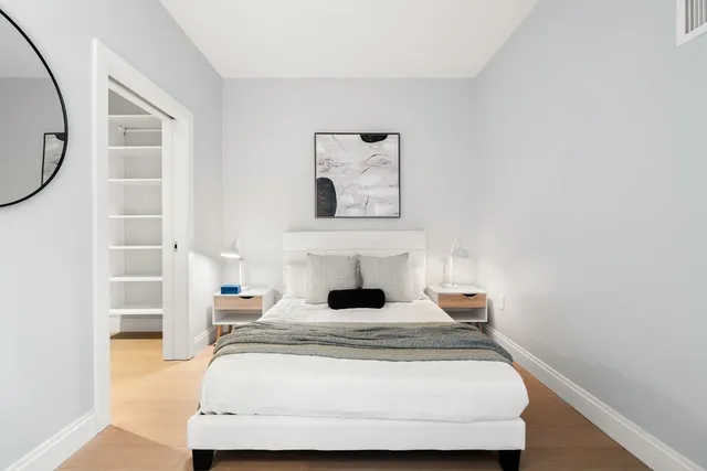 a bedroom with a bed and a window