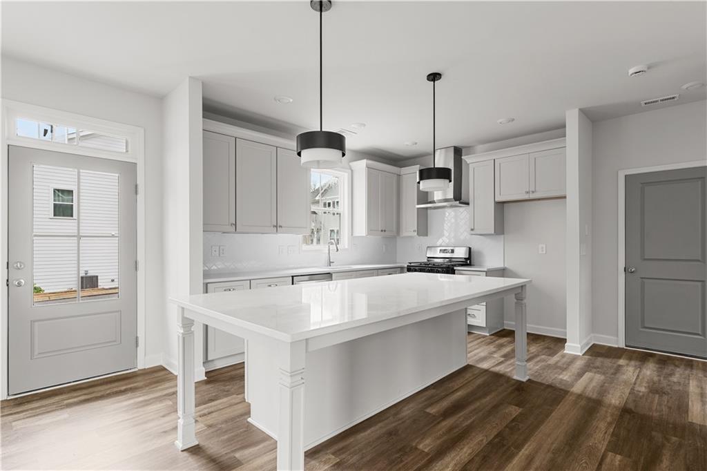 3810 Cottage Circle Clarkston, GA 30021 - Photo 2 of 11 a kitchen that has a sink a stove and chairs