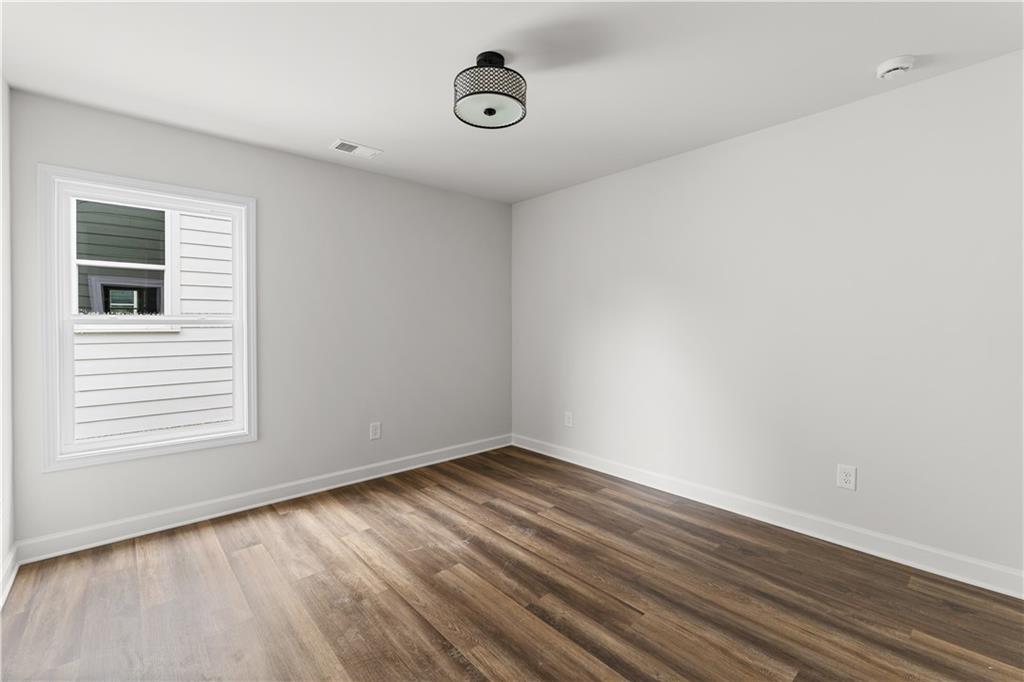 3810 Cottage Circle Clarkston, GA 30021 - Photo 4 of 11 a view of an empty room with wooden floor and a window