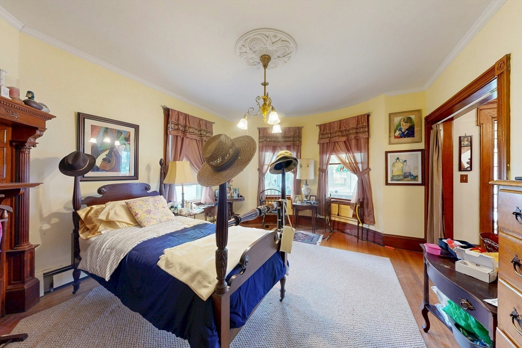 264 Court Road Winthrop, MA 02152 - Photo 11 of 26 a bedroom with bed and a chandelier