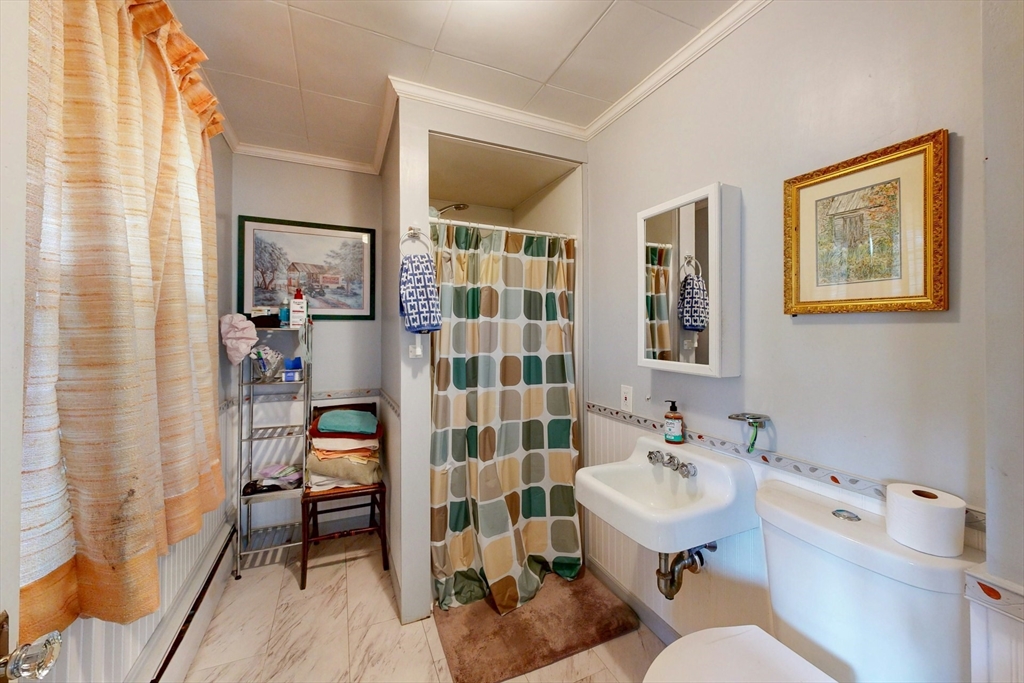264 Court Road Winthrop, MA 02152 - Photo 12 of 26 a bathroom with a sink toilet and shower