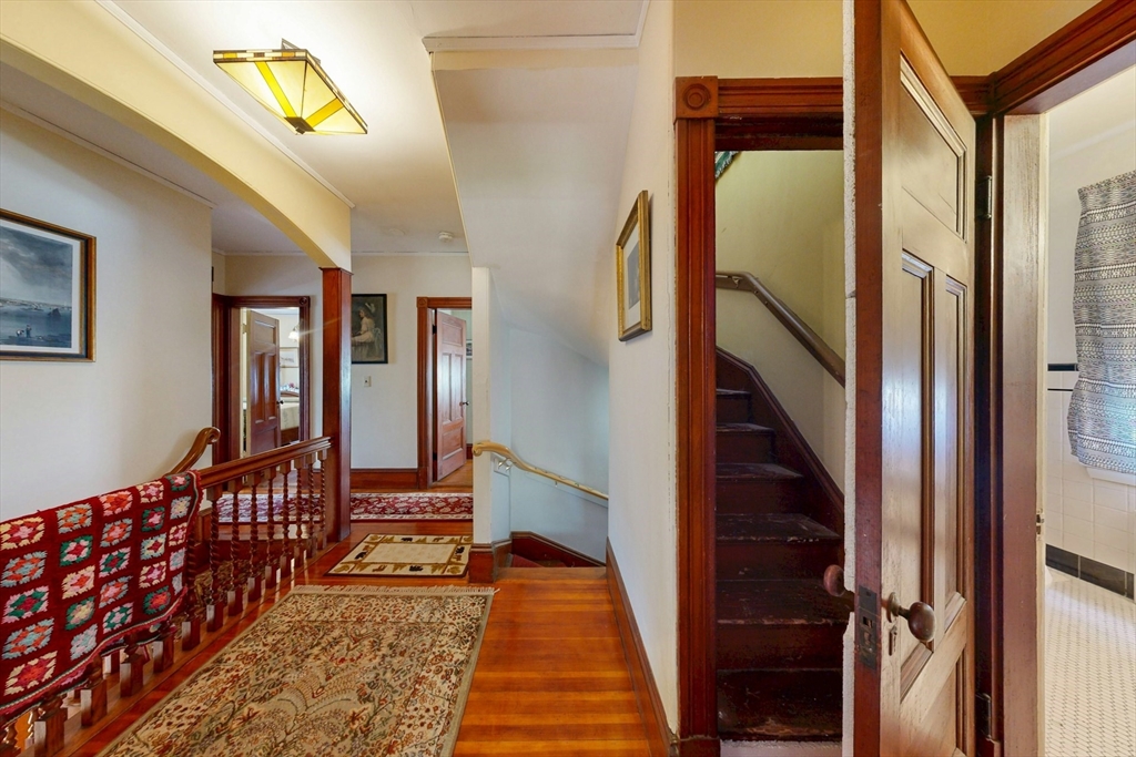 264 Court Road Winthrop, MA 02152 - Photo 17 of 26 a hallway with painting on the wall and a mirror
