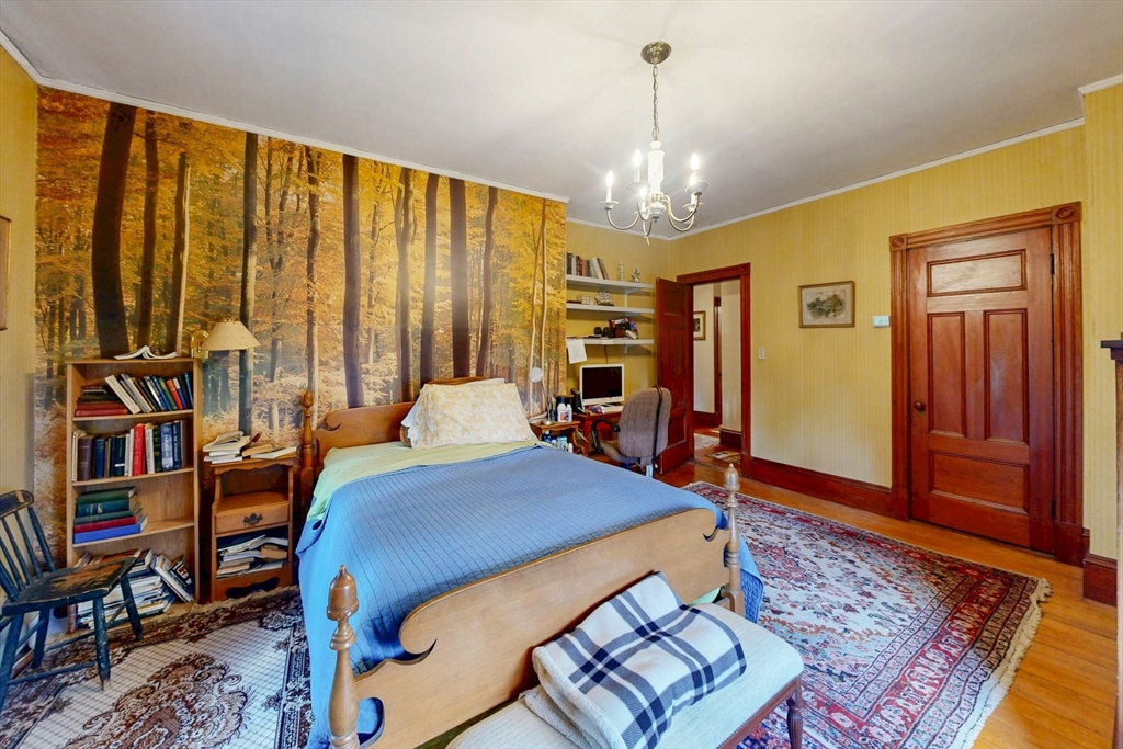 264 Court Road Winthrop, MA 02152 - Photo 19 of 26 a bedroom with furniture and a chandelier