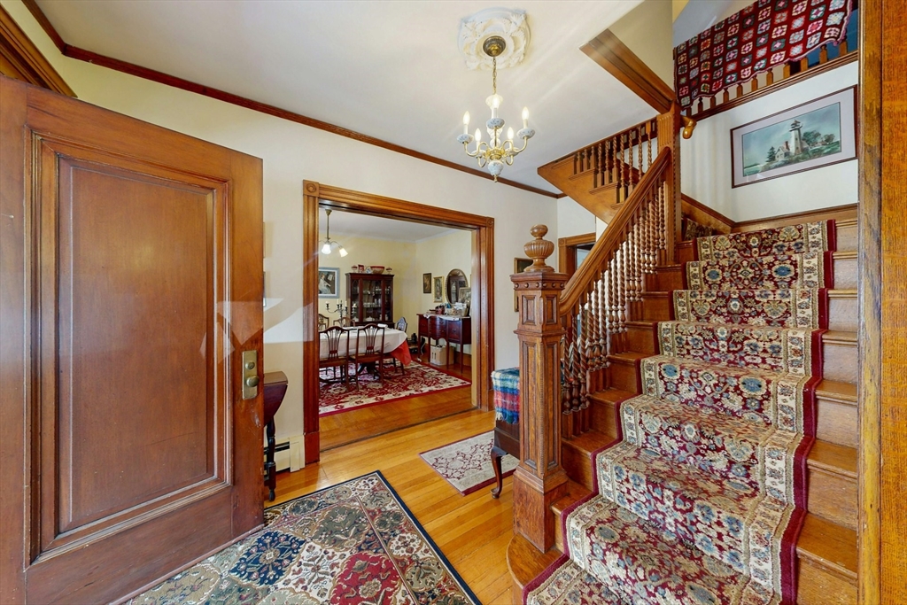 264 Court Road Winthrop, MA 02152 - Photo 2 of 26 a very nice looking bedroom with a large bed and a chandelier