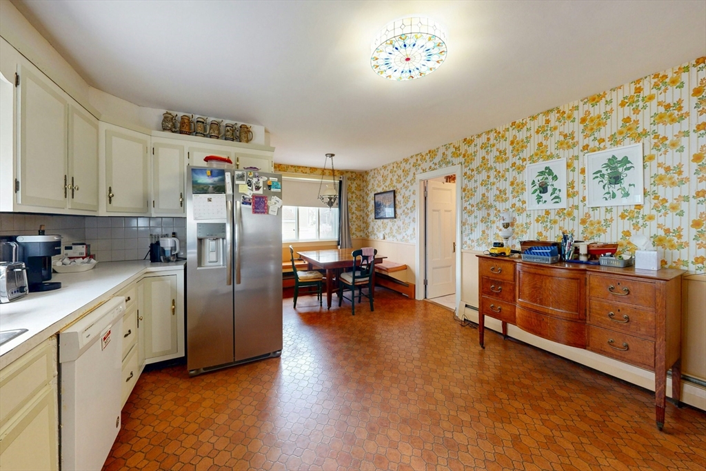 264 Court Road Winthrop, MA 02152 - Photo 8 of 26 a kitchen with stainless steel appliances granite countertop a refrigerator and a stove top oven