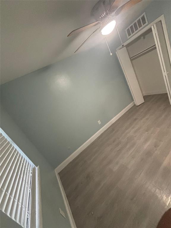 301 Rolston Road, Unit 305101 Irving, TX 75060 - Photo 7 of 7 Interior room with light gray-blue walls, wood-finish flooring, and white trim