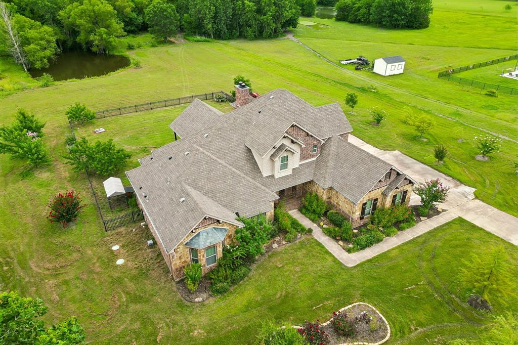 62 Trail Ridge Drive Melissa, TX 75454 - Photo 26 of 39 Fenced in backyard is great for pets and overlooks the large yard and pond. Long driveway offers plenty of parking for friends and family