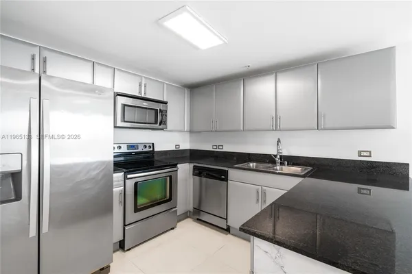 a kitchen with a sink stove and refrigerator