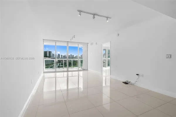 a view of a room with window and ceiling fan