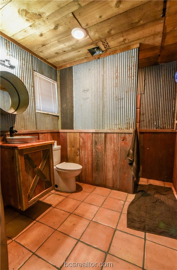 12200 Winn Road Kosse, TX 76653 - Photo 12 of 34 a bathroom with a sink a toilet and a window