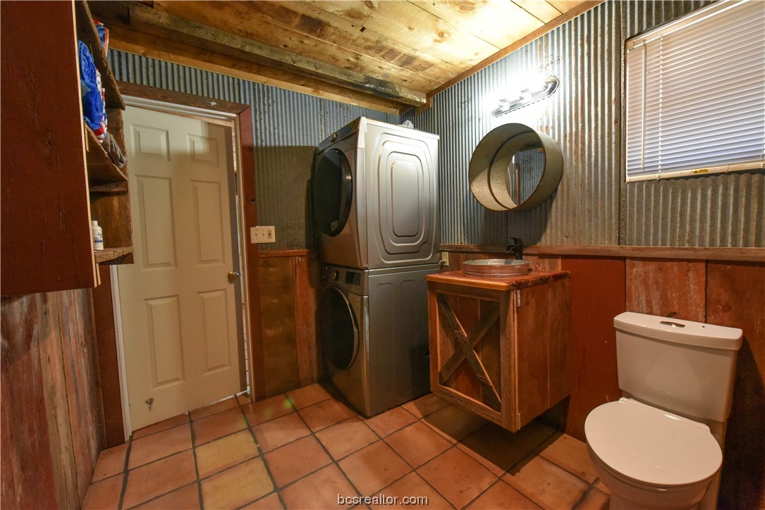 12200 Winn Road Kosse, TX 76653 - Photo 14 of 34 a bathroom with a toilet mirror and vanity