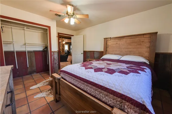 a bedroom with a bed and chandelier