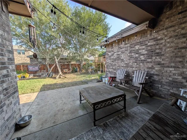 a view of a patio with table and chairs and potted plants