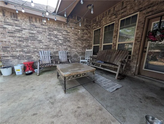 a backyard of a house with barbeque oven table and chairs