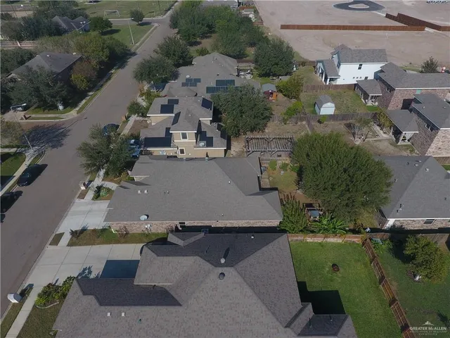 an aerial view of a house with a yard