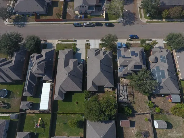 an aerial view of houses with outdoor space