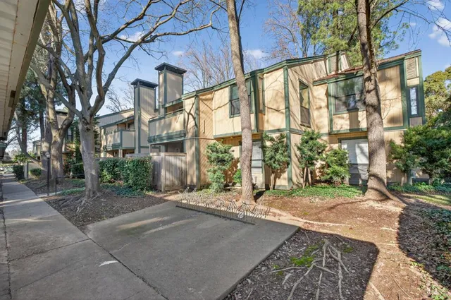 a view of a tall brick building next to a yard