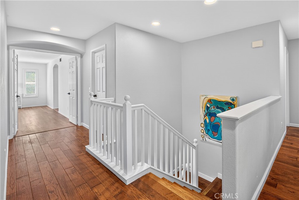 31928 Cercle Chambertin Temecula, CA 92591 - Photo 34 of 74 a view of a hallway to an entryway with wooden floor