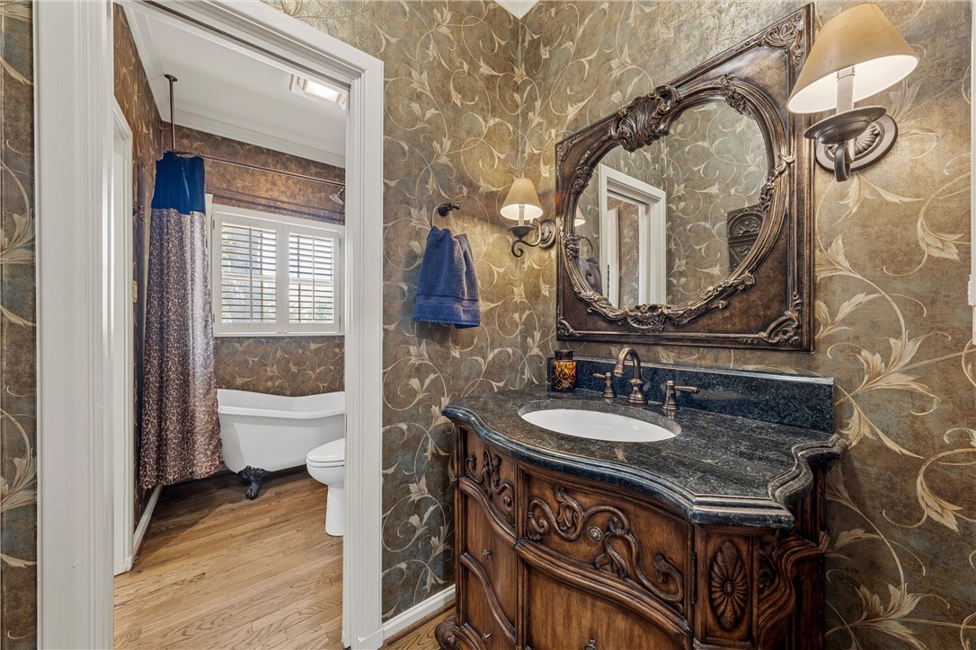 7110 Fish Pond Road Waco, TX 76710 - Photo 13 of 44 a bathroom with a sink a toilet and a mirror