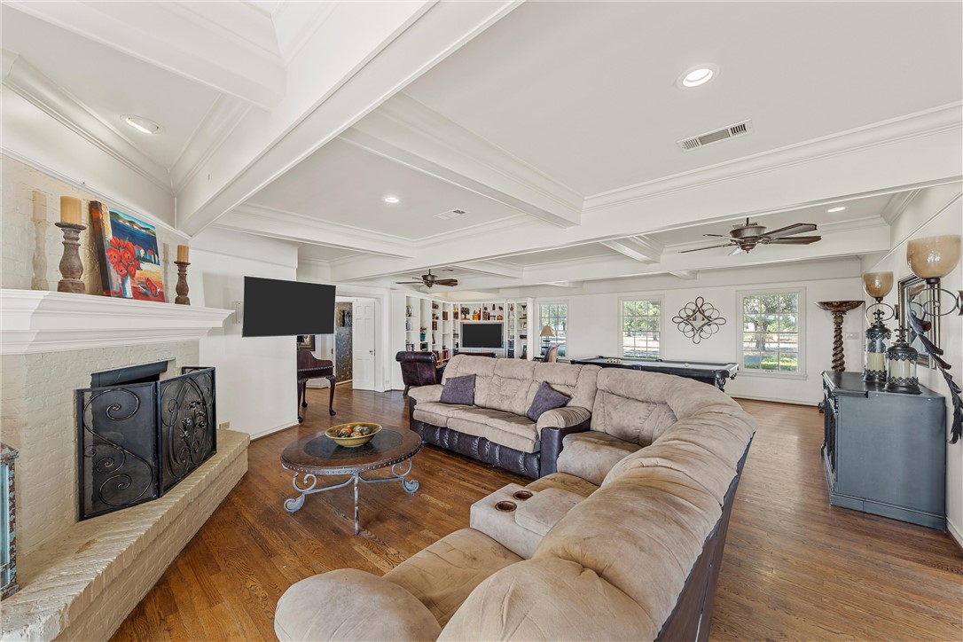 7110 Fish Pond Road Waco, TX 76710 - Photo 23 of 44 a living room with furniture a flat screen tv and a fireplace
