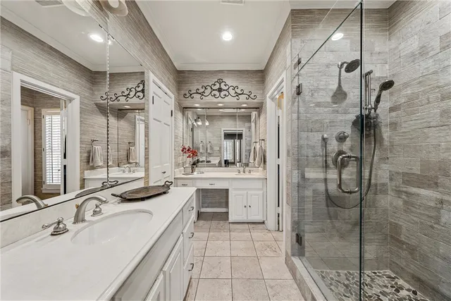a spacious bathroom with a shower sink and mirror