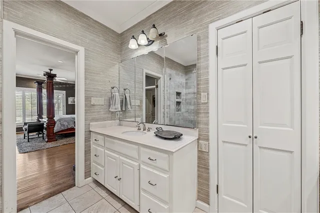 a bathroom with a granite countertop sink a mirror and a shower