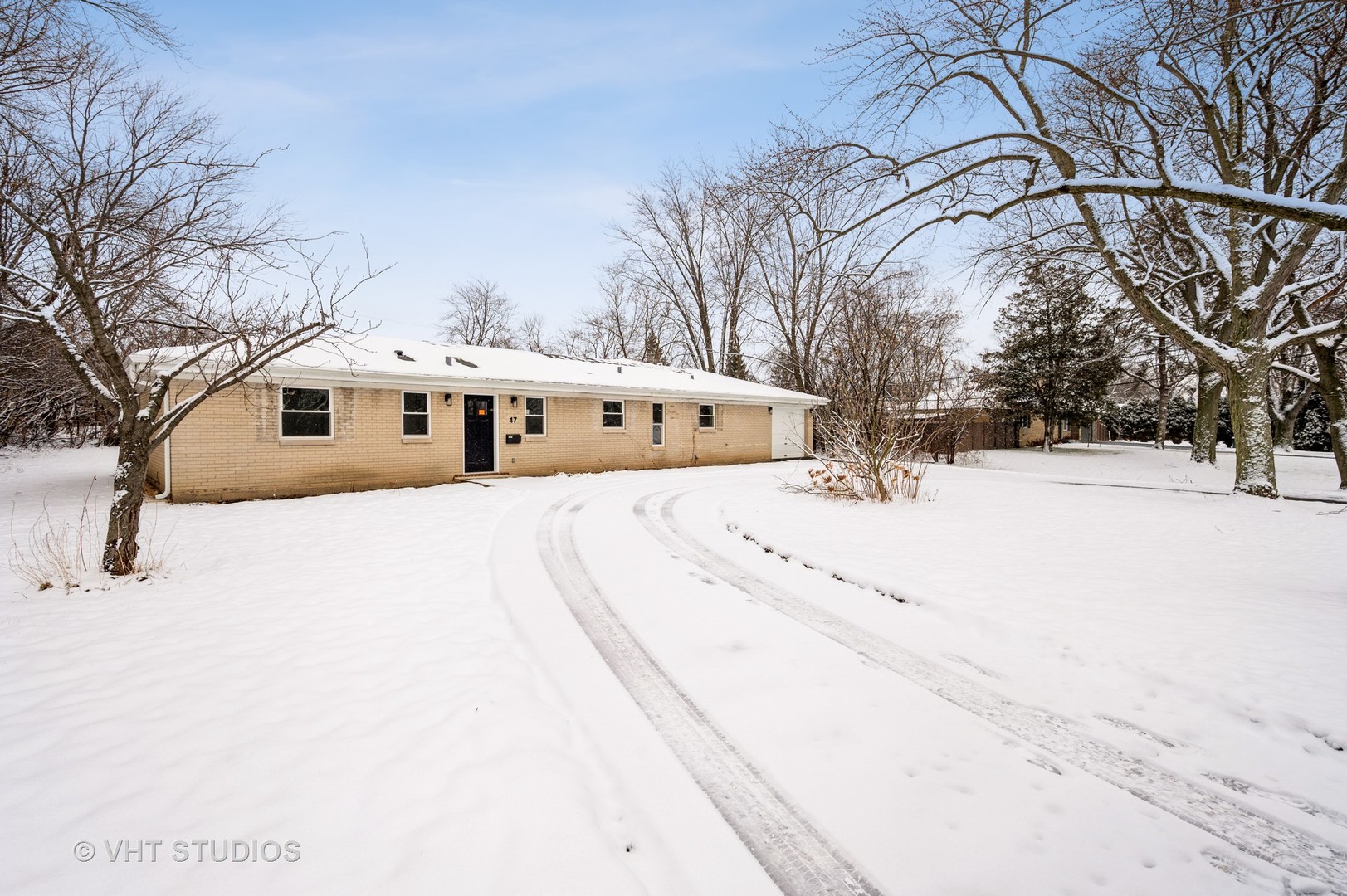 47 Birchwood Road Northbrook, IL 60062 - Photo 1 of 10 a front view of a house with a yard covered in snow