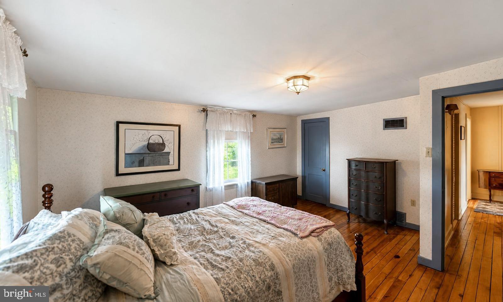 222 Blue School Road Perkasie, PA 18944 - Photo 36 of 77 a bedroom with a bed and a chandelier