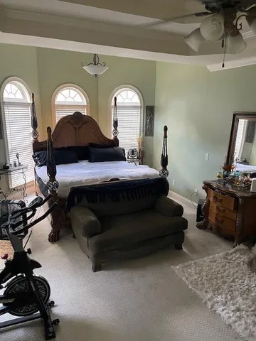 a bedroom with a bed and a mirror on dresser