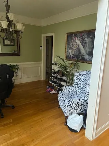 a living room with furniture rug and wooden floor