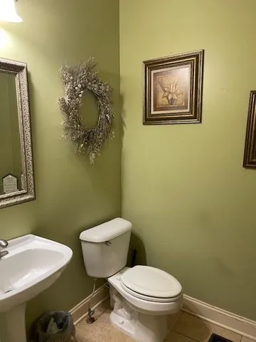 a white toilet sitting next to a bathroom sink