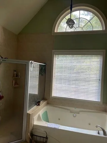 a bathroom with a bathtub and a window