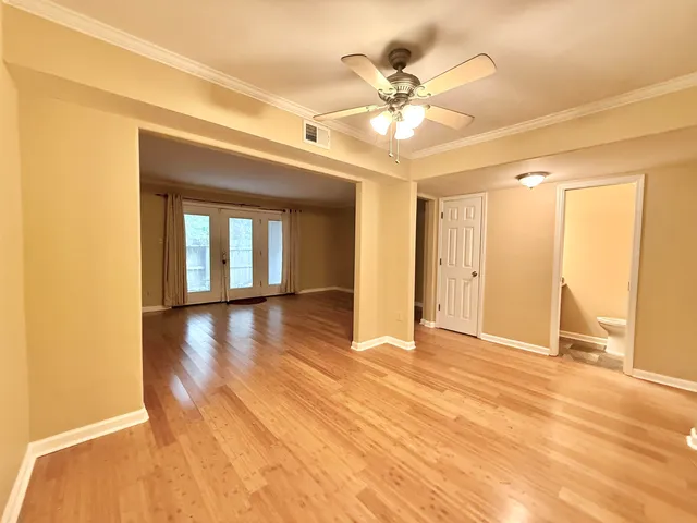 a view of empty room with wooden floor