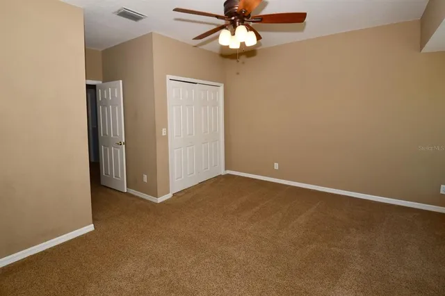 a view of a fountain in front of house with a big yard