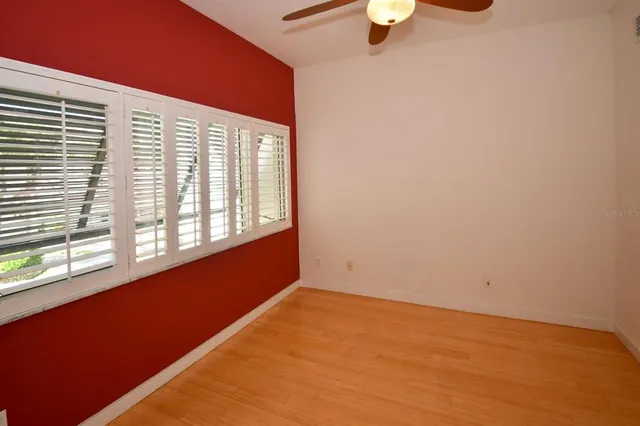 a view of a livingroom with a piano and wooden floor