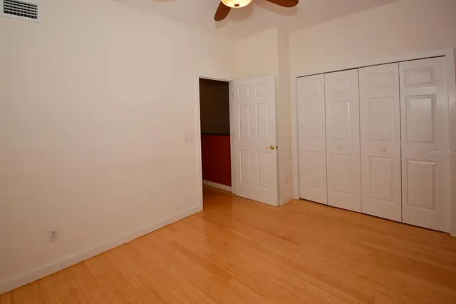 a bathroom with a granite countertop sink and a toilet