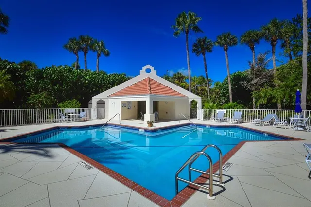 a view of a house with pool and sitting area