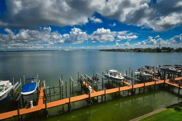 a wooden bench sitting in front of a building