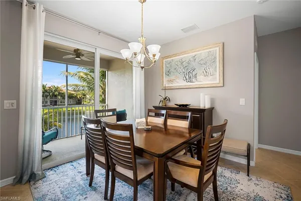 a dining room with furniture a rug and a chandelier