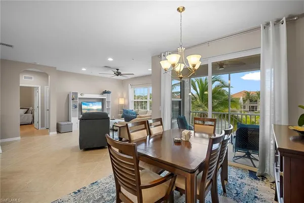 a dining room with furniture a chandelier and a rug